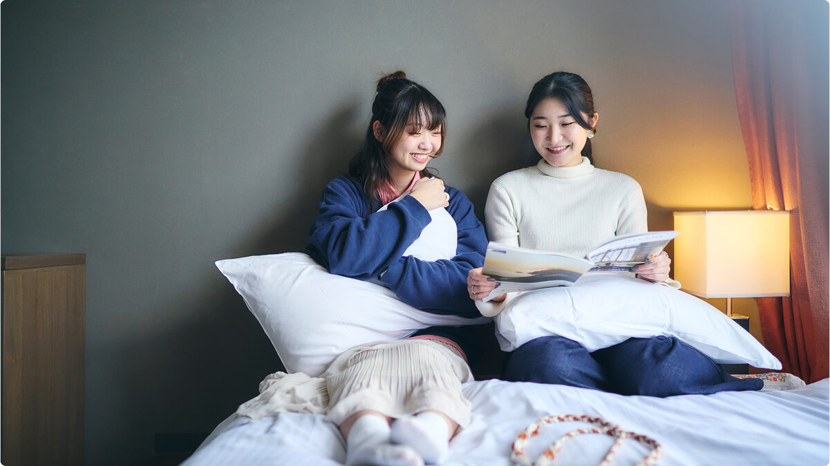 ゲストが部屋のベッドでくつろぐ様子